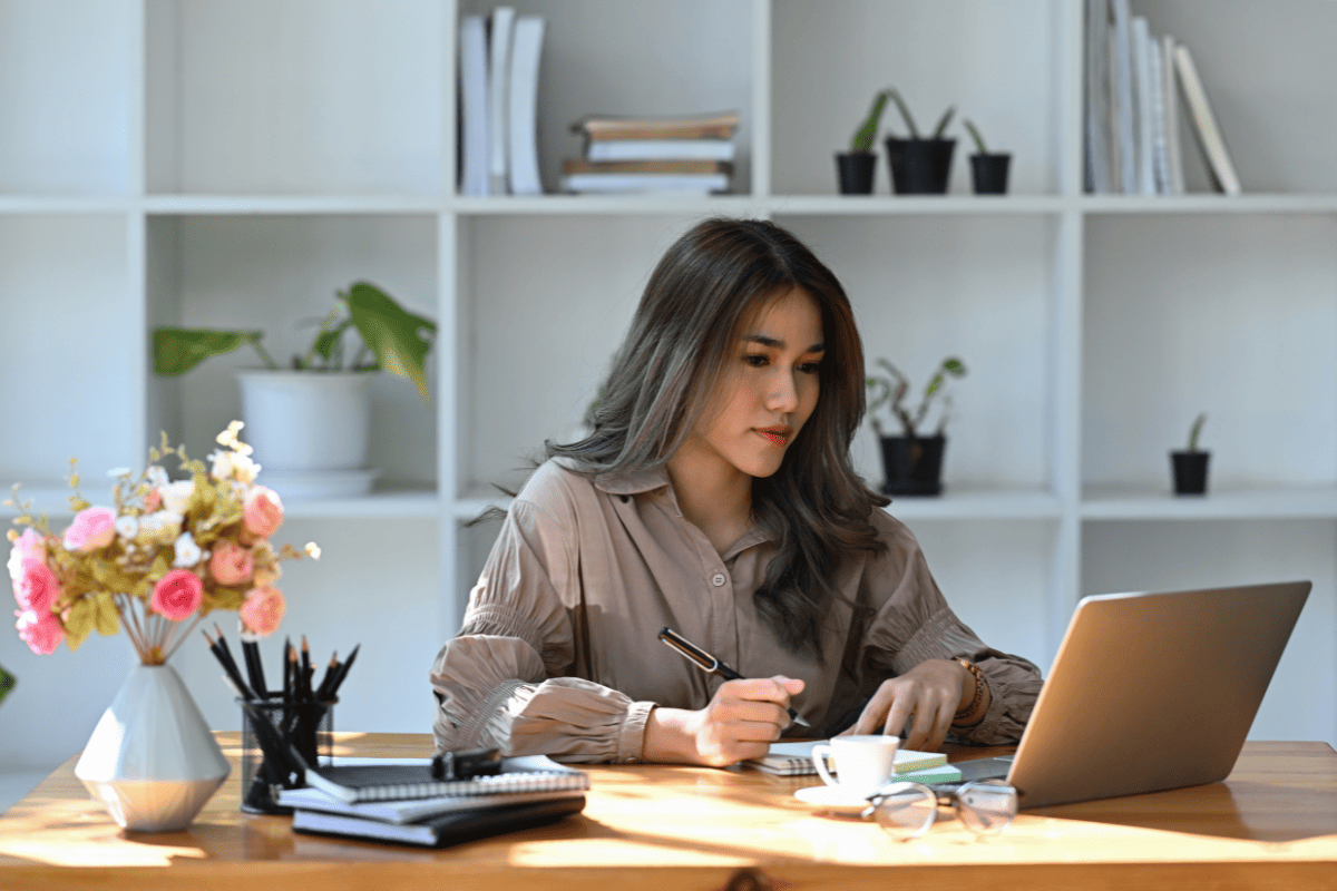 A professional woman working on a laptop.