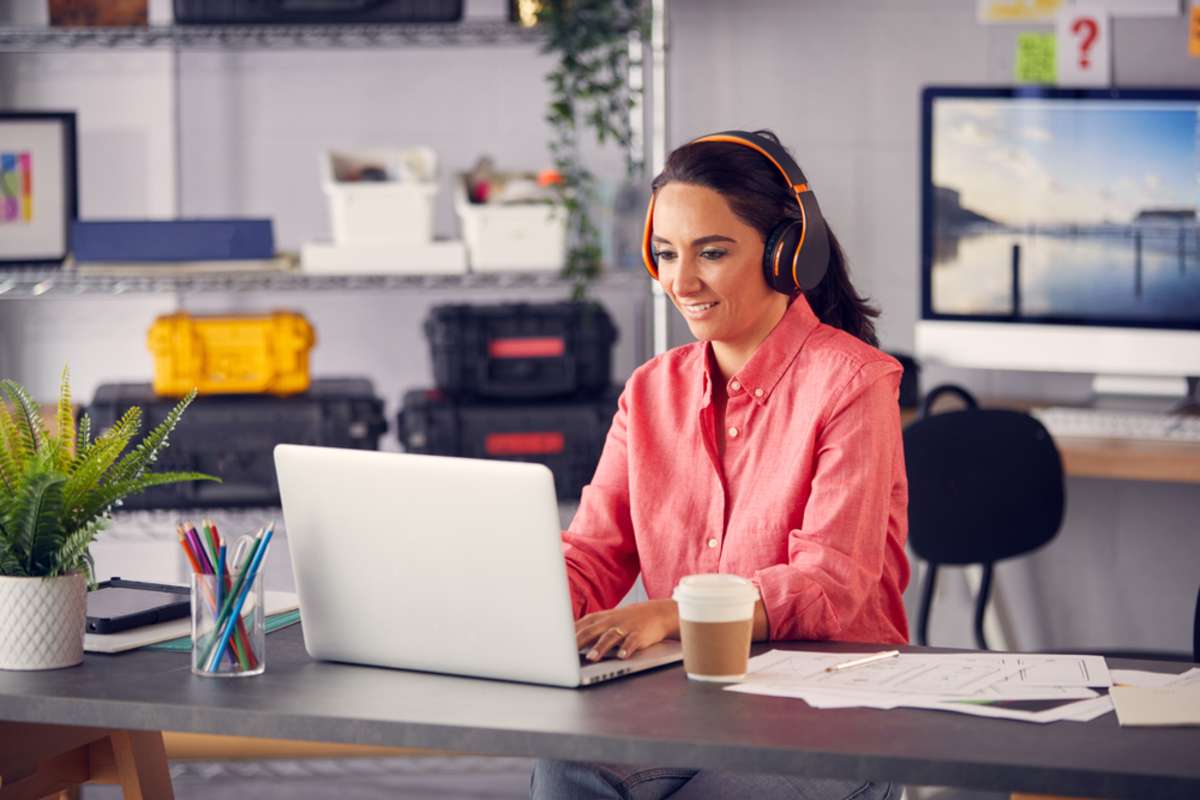 Virtual assistant at desk watching an online training course. 