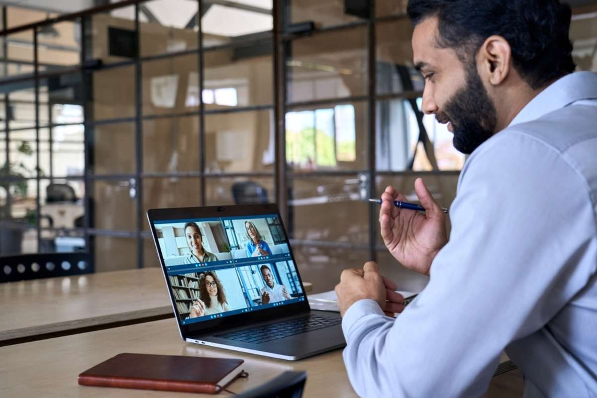 Smiling businessman having working videocall, remote team members concept. 