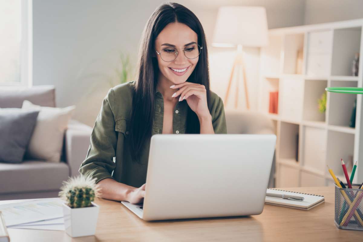 Portrait of charming successful cheerful focused girl working remotely creating finance it presentation report at home house flat indoor