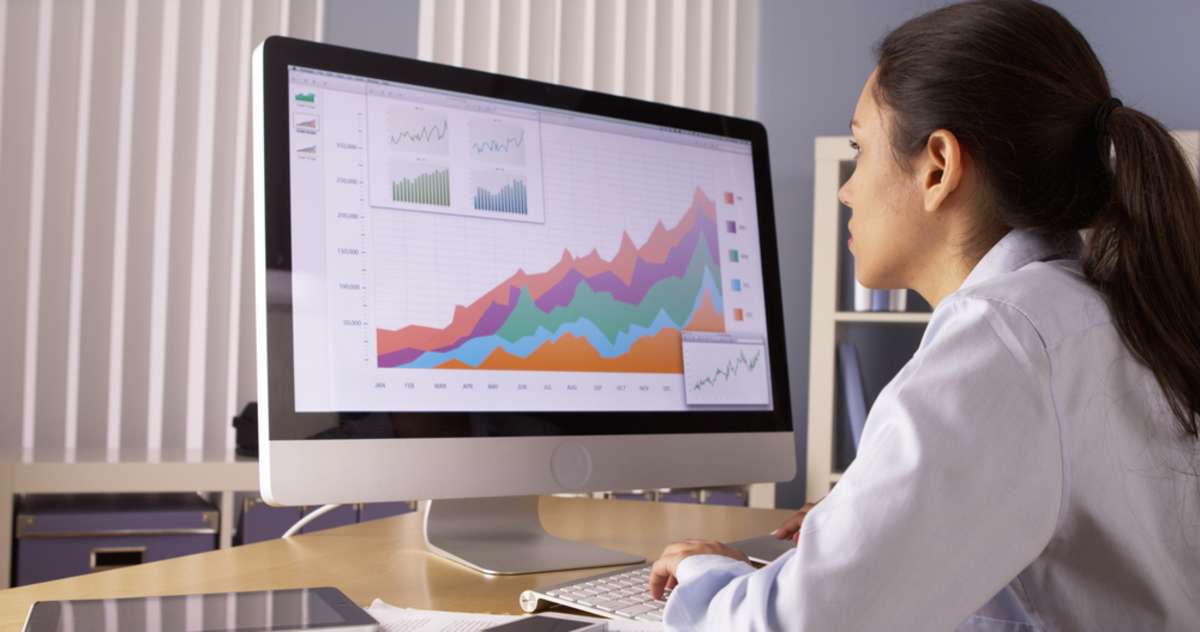 Young woman looks at analysis on a computer screen, virtual marketing assistant concept