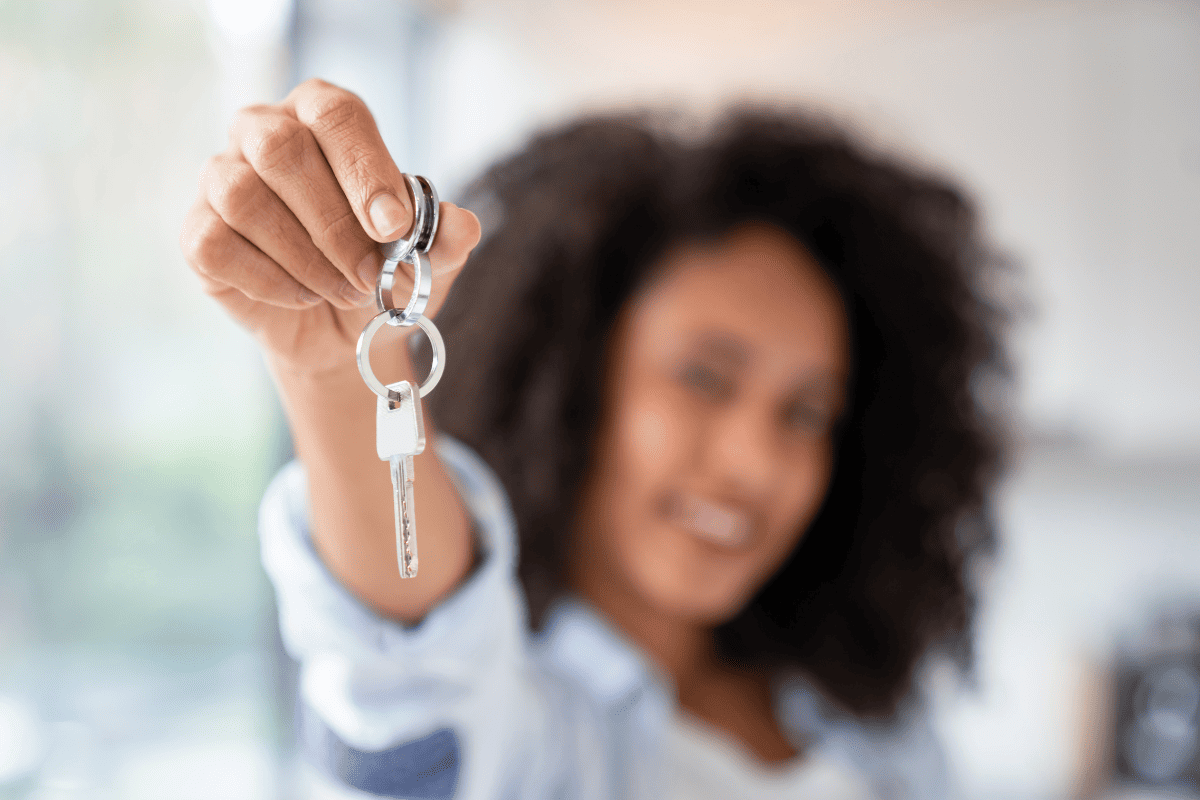 A woman holding keys.